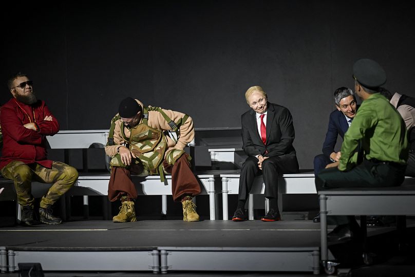 Bulgarian artist Radena Valkanova(3R), as Vladimir Putin and Julian Vergov (2ndL) as Yevgeny Prigozhin, perform on stage during the play "Haga"