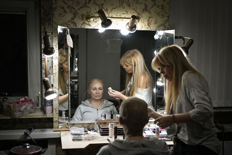 Bulgarian artist Radena Valkanova (L) prepares with make-up backstage ahead of her performance in the role of Russian President Vladimir Putin in the play "Haga"