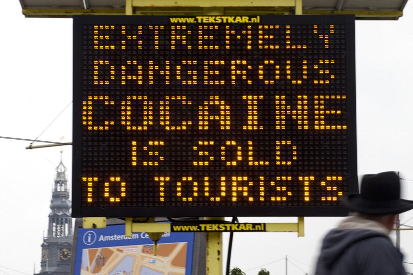 A sign warns of extremely dangerous cocaine being sold to tourists is seen outside Central Station in Amsterdam, November 2014