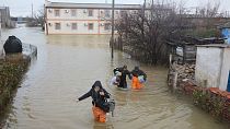 Local residents are seen evacuated from the flooded village of Pribrezhnoe in Crimea on November 27, 2023, following a storm.