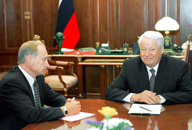 Russian President Boris Yeltsin smiles as he listens to acting Prime Minister Vladimir Putin, during their meeting in Moscow's Kremlin, August 1999