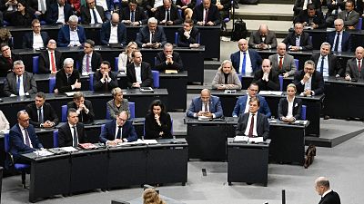 German Chancellor Olaf Scholz (R) addresses delegates at the Bundestag (lower house of parliament) on November 28, 2023 in Berlin, Germany.