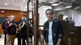 US journalist Evan Gershkovich, arrested on espionage charges, stands inside a defendants' cage before a hearing to consider an appeal on his extended pre-trial detention.