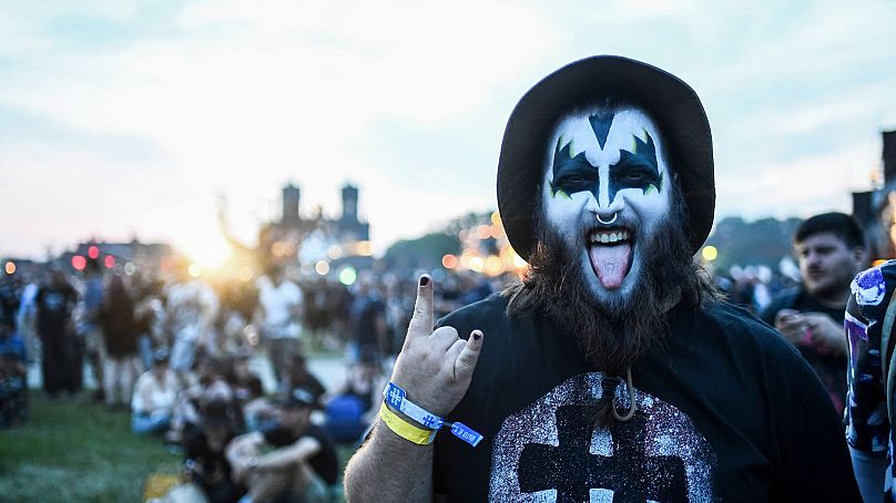 A heavy metal fan gestures as he attends a concert during the Hellfest Summer Open Air rock festival in Clisson, western France, on June 15, 2023.