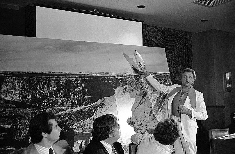 Evel Knievel shows how he plans to jump across Snake River Canyon in Twin Falls, Idaho, during a news conference in New York, June 24, 1974.