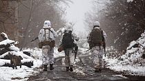Ukrainian soldiers walks at the line of separation from pro-Russian rebels near Katerinivka, Donetsk region, Ukraine, Tuesday, Dec 7, 2021.