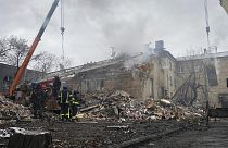 رجال الإنقاذ أمام مبنى تضرر بسبب القصف الروسي في دونيتسك