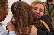 Former captive Danielle Aloni embraces family members upon her arrival at a hospital in Israel, following her release by Hamas in Gaza on 24 November 24