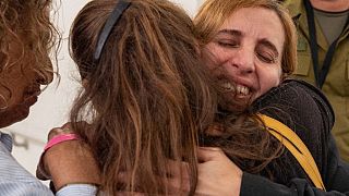 Former captive Danielle Aloni embraces family members upon her arrival at a hospital in Israel, following her release by Hamas in Gaza on 24 November 24