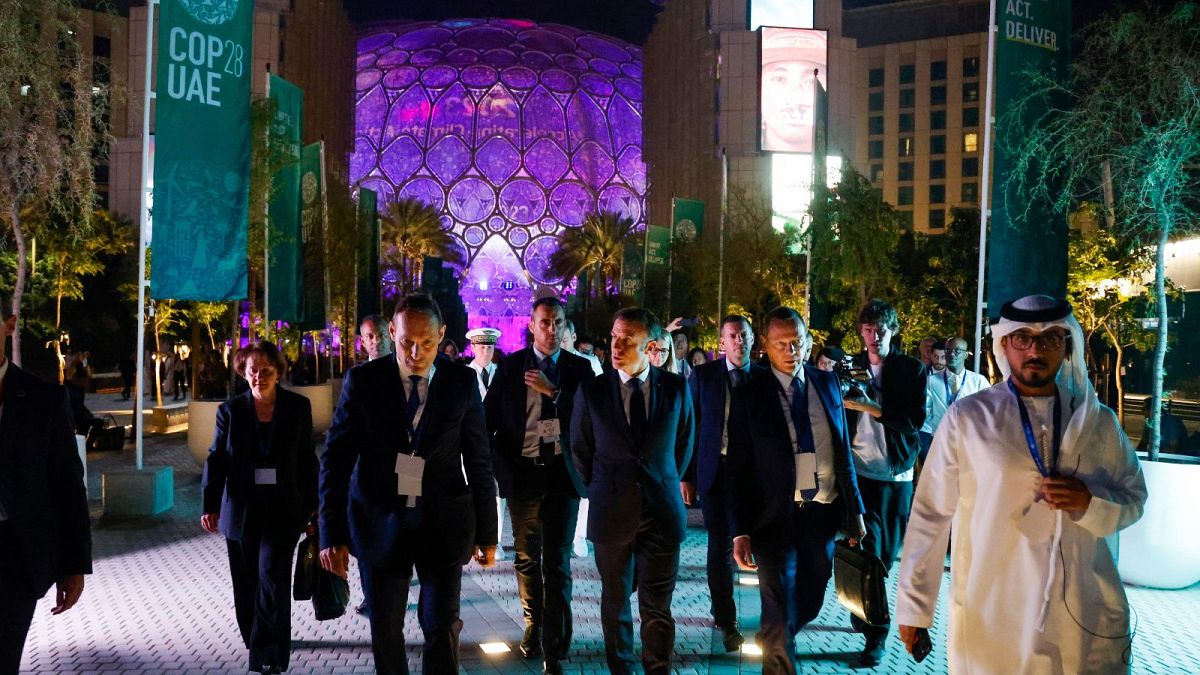 France's President Emmanuel Macron leaves the venue for bilateral meetings on the sidelines of the COP28 United Nations climate summit in Dubai, 1 December 2023.