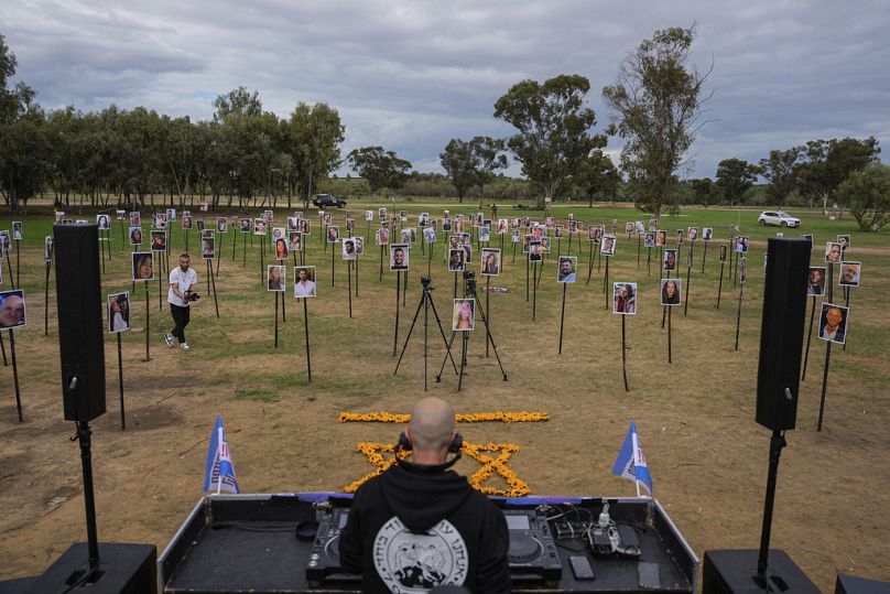 Photos of people killed and taken captive by Hamas during the Nova music festival are displayed at the site, as Israeli DJs play, to commemorate the massacre on Tuesday