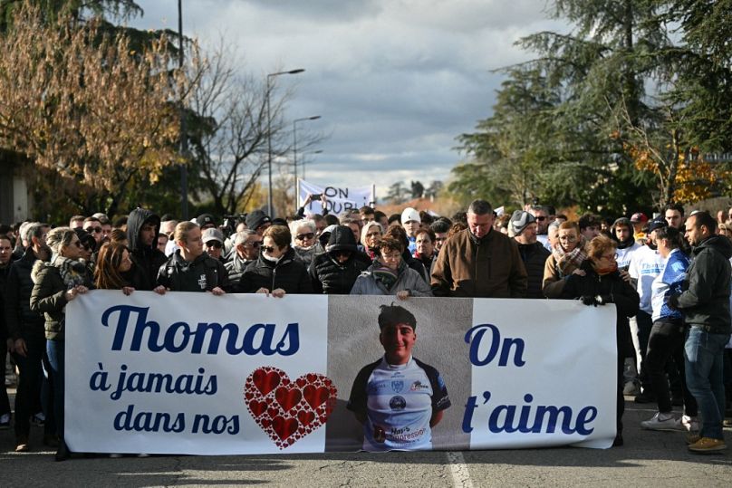 People march in Romans-sur-Isere on November 22, 2023, as they take part in a "Marche Blanche" (White March) to pay tribute to Thomas.