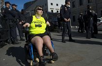 A disabled woman affected by phocomelia (malformation of the limbs) due to thalidomide medicine drives a wheelchair during a protest in front of the Spanish parliament in 2015