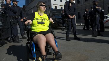 A disabled woman affected by phocomelia (malformation of the limbs) due to thalidomide medicine drives a wheelchair during a protest in front of the Spanish parliament in 2015
