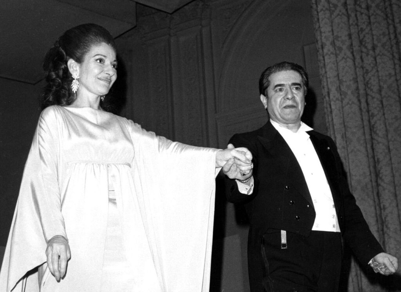 Giuseppe di Stefano holds hands with Callas on the Carnegie Hall stage in New York City on March 5, 1974, after their participation in the Met Opera's guild benefit concert.