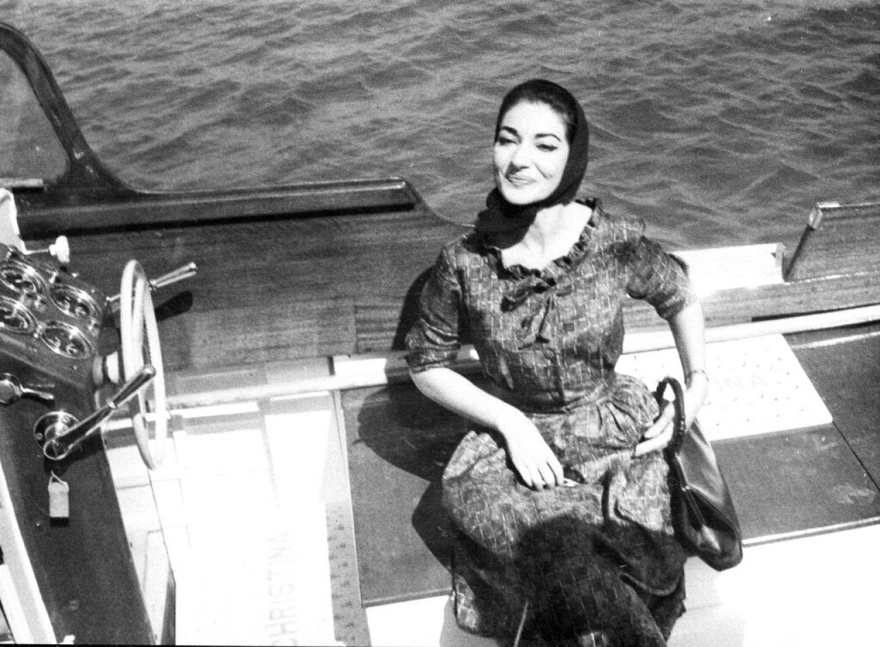 Satisfied, Maria Callas evades reporters in Athens by sailing in a motor launch after arriving from Bilbao, Spain, on Sept. 18, 1959.