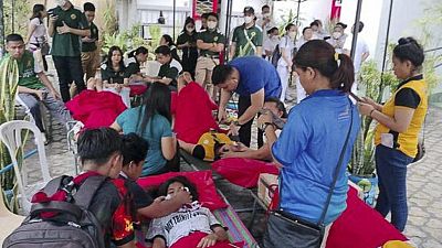 n this handout photo provided by the Philippine Red Cross, volunteers attend to people affected by an earthquake that struck General Santos City, South Cotabato.