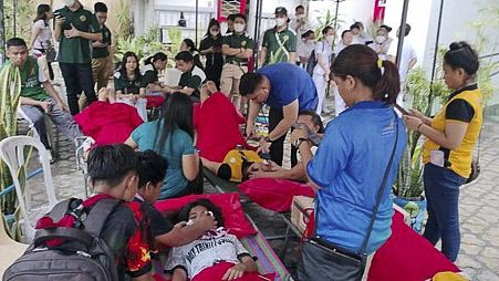 n this handout photo provided by the Philippine Red Cross, volunteers attend to people affected by an earthquake that struck General Santos City, South Cotabato.