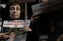 Irena Tati holds a picture of her grandson, Alexander, held by Hamas in Gaza, during protest in Tel Aviv, Israel, Dec. 2, 2023. 