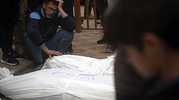 Palestinians mourn their relatives killed, in the Israeli bombardment, at the Nasser hospital in town of Khan Younis, southern Gaza Strip, Wednesday, Nov. 22, 2023.