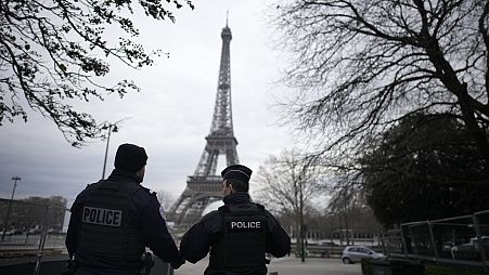 French policemen patrol near the Eiffel Tower 