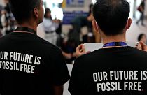 Activists wear shirts that read "our future is fossil free" at COP28.