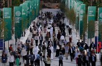 People walk through the COP28 UN Climate Summit.