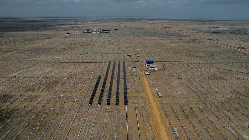 Solar panels are installed at an under-construction site of Adani Green Energy Limited's Renewable Energy Park near the India-Pakistan border, 21 September 2023.