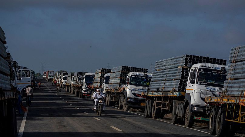 Trucks carry aluminium alloy frames to Adani Green Energy Limited's Renewable Energy Park near Khavda, India, 21 September 2023.