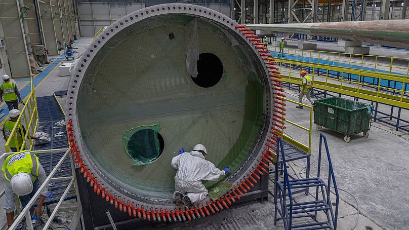 Employees work on a wind turbine blade at the Adani New Industries Limited in the port town of Mundra in Western India's Gujarat state, India, 20 September 2023. Employees work on a wind turbine blade at the Adani New Industries Limited in the port town of Mundra in Western India's Gujarat state, India, 20 September 2023.