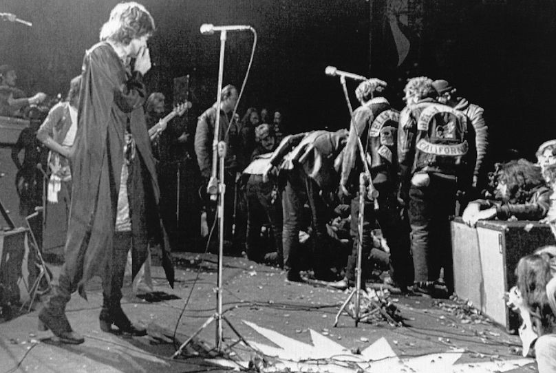 Mick Jagger stops performing at the Altamont Rock Festival at Livermore, California, Dec. 8, 1969, while Hells Angels cross stage during melee to help fellow motorcyclists.