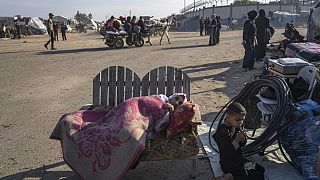 Palestinians displaced by the Israeli bombardment of the Gaza Strip gather at a tent camp, in Rafah, southern Gaza strip