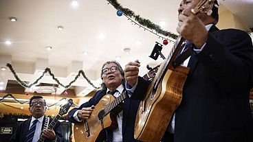 Mexican singers sing a bolero at a cantina in Mexico City on November 4, 2023.