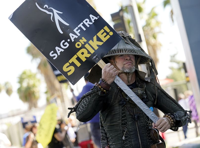 SAG-AFTRA member Bruce D. Mitchell participates in a post apocalyptic-themed picket line outside Netflix studios - 8 Nov. 2023, in Los Angeles.