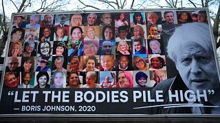 Carrinha mostra cartaz de protesto conta a gestão da pandemia por Boris Johnson