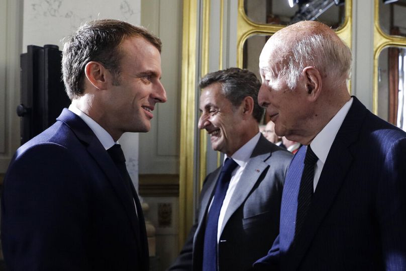 French President Emmanuel Macron greets former President Valéry Giscard d'Estaing at the Constitutional Council in Paris, October 2018