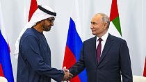 Russian President Vladimir Putin, right, and United Arab Emirates President Sheikh Mohamed bin Zayed Al-Nahyan shake hands.