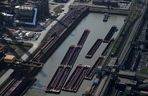 This aerial view shows cargo vessels at the plant of German industrial conglomerate ThyssenKrupp in Duisburg, western Germany