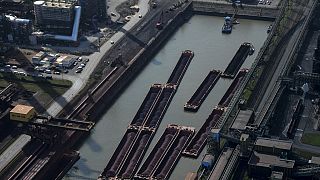 This aerial view shows cargo vessels at the plant of German industrial conglomerate ThyssenKrupp in Duisburg, western Germany