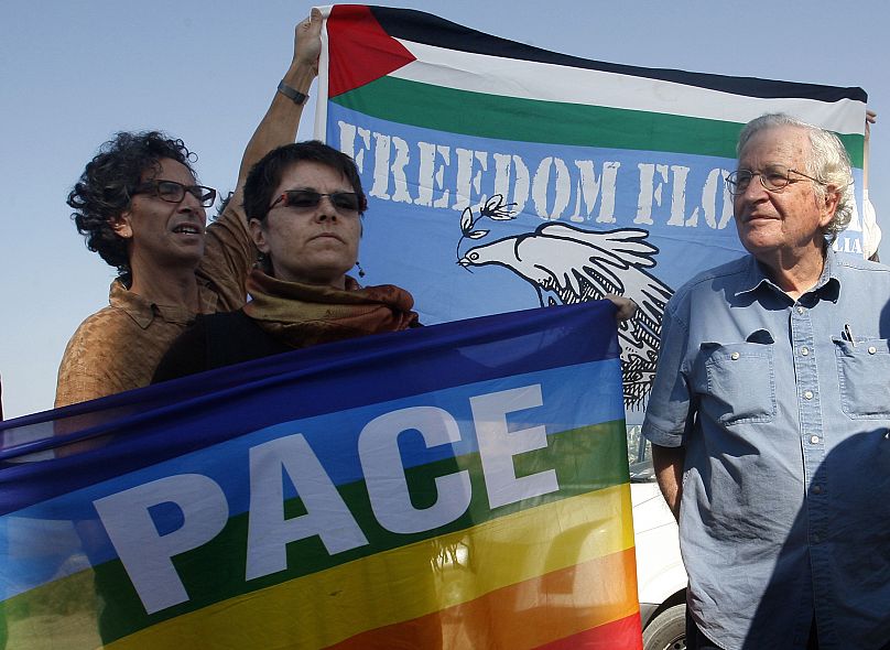 Noam Chomsky, right, stands during a press conference to support the Gaza-bound flotilla in the port of Gaza City, Saturday, Oct. 20 , 2012.