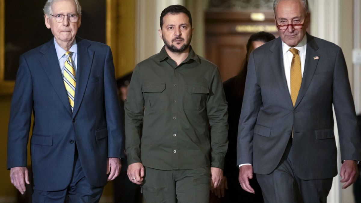 FILE - Ukrainian President Zelenskyy, walks with Senate Minority Leader Mitch McConnell of Ky. and Senate Majority Leader Chuck Schumer of N.Y. at Capitol Hill