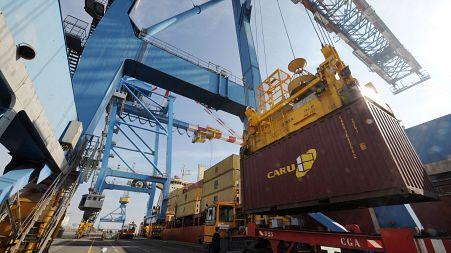 Ship-to-shore gantry cranes unload a cargo, on February 27, 2012, at the Montoir-de-Bretagne terminal, western France.