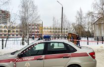 Law enforcement officers stand guard outside Gymnasium Number Five following a shooting, in Bryansk on Thursday