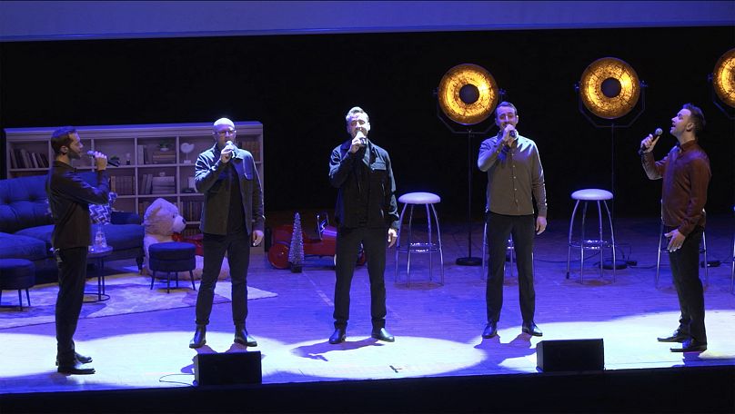 Members of the band "Dad Harmony" sing on stage during a concert in Norrkoping, Sweden.