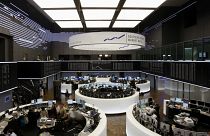 Brokers work at the stock exchange in Frankfurt, central Germany