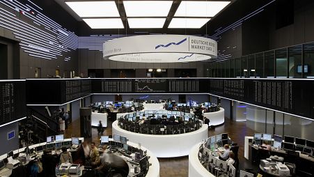 Brokers work at the stock exchange in Frankfurt, central Germany