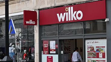 A cyclist rides past a branch of "Wilko" in west London on August 3, 2023. Wilko, August 3, has said it intends to appoint administrators, potentially putting up to 12,000 job