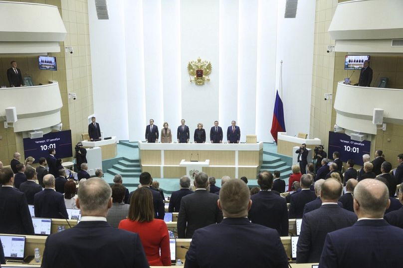 lawmakers of Federation Council of the Federal Assembly of the Russian Federation listen to the national anthem prior to a session in Moscow, Russia, on Thursday