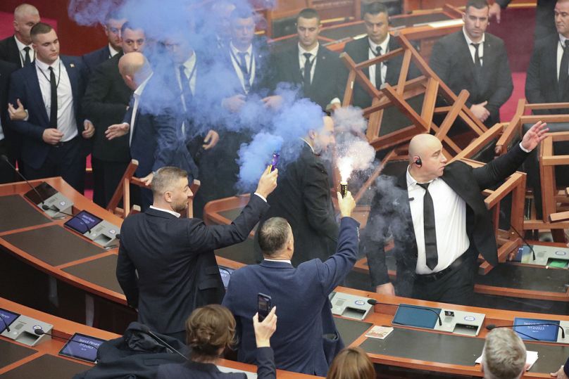 Members of the opposition hold flares in the parliament building in Tirana, Albania