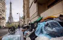 Uncollected rubbish piles up on a street near the Eiffel Tower in Paris, 24 March 2023. 